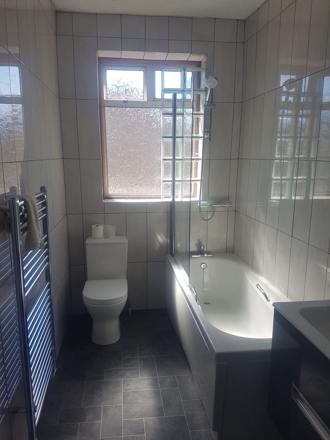 Full bathroom refit with shower bath, towel radiator and slate floor