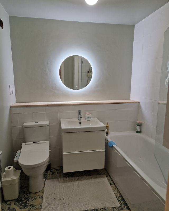 Cloakroom with an LED mirror and patterned tiles
