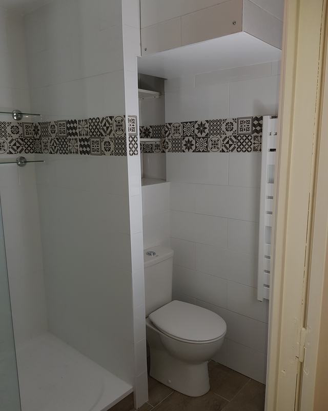 Dated cubicle replaced with a walk-in shower